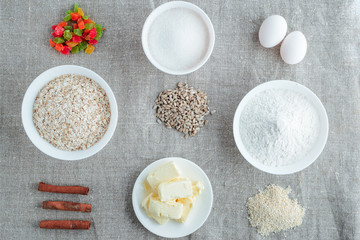 Ingredients for baking oatmeal cookies on a light background
