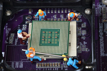 Selective focus of miniature engineer and worker repair CPU processor,  mainboard computer and use for business background.