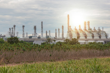 Fototapeta na wymiar Oil and gas refinery industry plant, chemical storage tanks and sunlight of sunset at evening