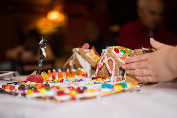 Hand Adjusts Gingerbread House