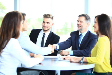 Business people shaking hands, finishing up a meeting.