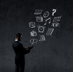 Businessman sending sms with a smartphone. Black background with