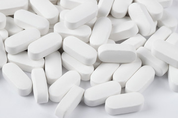  white pills oval shape on a white background