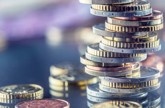 Euro Coins stacked on each other in different positions. Money concept.
