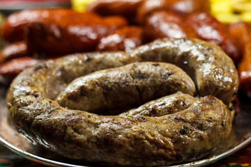 Freshly cooked sausages on a grill close-up. A background of sausages cooked on charcoal.