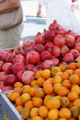 Trade in the vegetable market in Europe, ripe garnets and tangerines on the counter