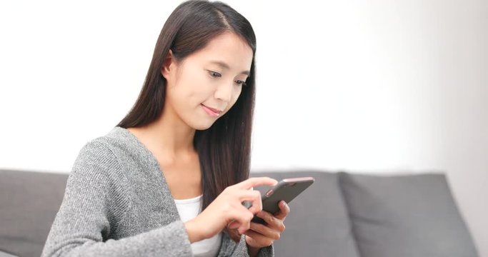 Woman look at smart phone at home