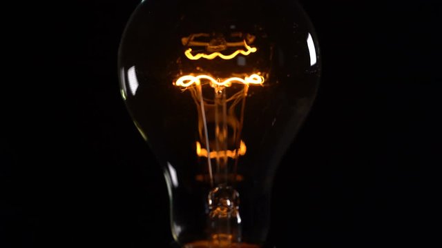 flickering light bulb on black background