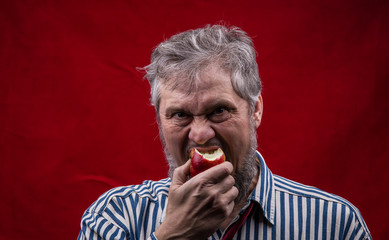 portrait of a man eating an apple