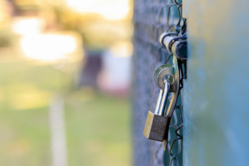 closeup old master key and rusty lock with soft-focus and over light