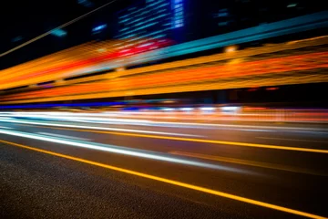 Acrylic prints Highway at night the light trails on the modern building background.