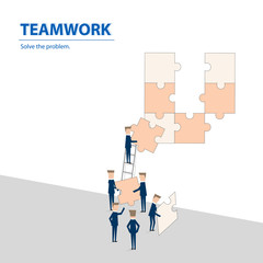 Businessmen helping together to fulfill the puzzle by pieces together in a logical way, in order to arrive at the correct solution.