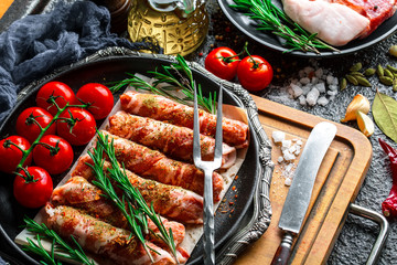 Raw meat on the kitchen table on a metallic background in a composition with cooking accessories