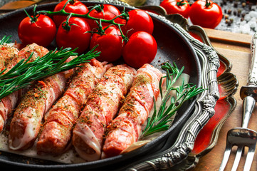 Raw meat on the kitchen table on a metallic background in a composition with cooking accessories