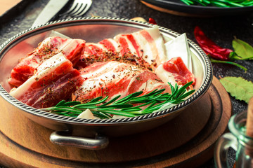 Raw meat on the kitchen table on a metallic background in a composition with cooking accessories