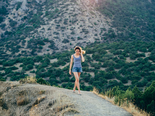 Naklejka premium happy beautiful girl with smile on background of sunset in the summer