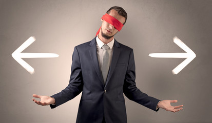 Covered eye businessman choosing direction