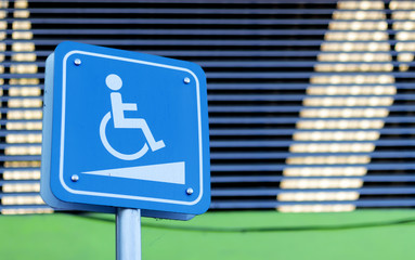 disability car park sign with soft-focus and over light in the background
