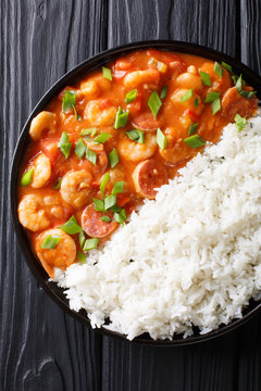 Traditional Louisiana gumbo with shrimp, sausage and rice macro on a plate. Vertical top view