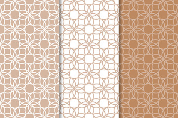 Brown and white geometric ornaments. Set of seamless patterns