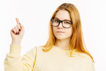 Serious young woman with glasses, forefinger up