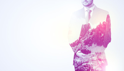 Businessman standing with mountain graphic