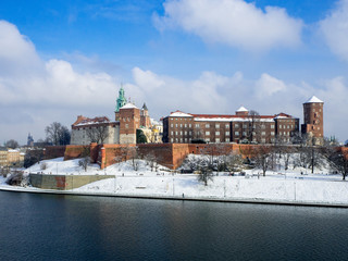 Kraków, Poland. Historic royal Wawel Castle, Cathedral with Renaissance Sigmund Chapel with golden dome and Vistula river in winter.