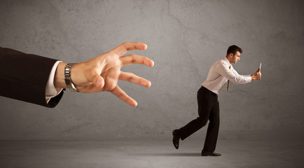 Businessman running from hand