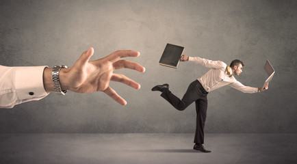 Businessman running from hand