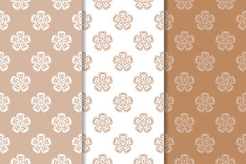 Brown floral backgrounds. Set of seamless patterns