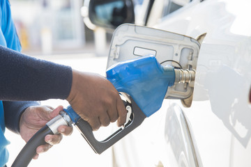 Filling gas at the station. Refill oil, gasoline, diesel vehicle.Hand refilling the car with fuel.