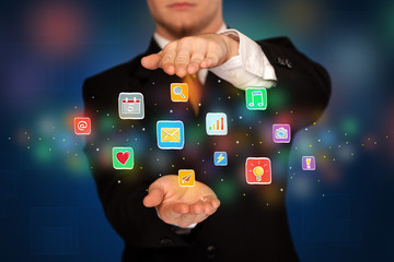 Businessman holding application icons