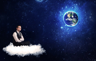 Man sitting on cloud looking at planet earth