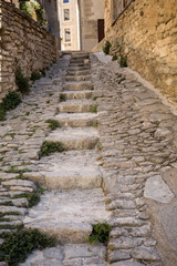 Fototapeta na wymiar Steep alley with medieval houses in Gordes. Provence, France