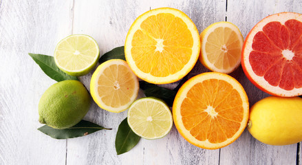Naklejka na ściany i meble Citrus background. Assorted fresh citrus fruit. Lemon, orange lime, grapefruit. Fresh and colorful concept.