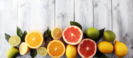 Citrus background. Assorted fresh citrus fruit. Lemon, orange lime, grapefruit. Fresh and colorful concept.