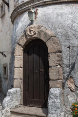 Closed Wooden Door, Stone Wall and Lamp