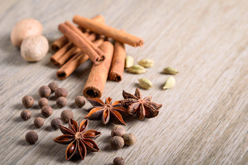 Various Spices background. Cinnamon sticks and anise stars close-up on wood background
