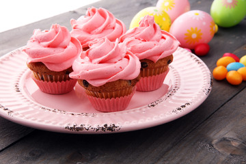 Tasty cupcakes on wooden background. Birthday cupcake in pink color
