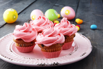 Tasty cupcakes on wooden background. Birthday cupcake in pink color