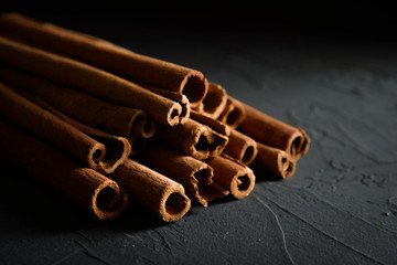  shelves of cinnamon in dark colors on a dark concrete stone background