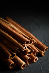  shelves of cinnamon in dark colors on a dark concrete stone background