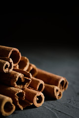  shelves of cinnamon in dark colors on a dark concrete stone background