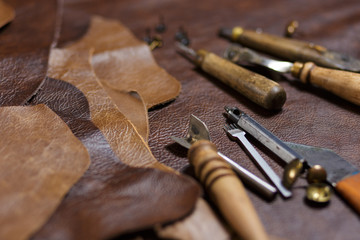 Crafting tools on natural cow leather in the tailoring workshop.