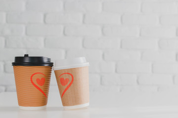 Two coffee cup with heart shape on white brick wall background.Concept of happy Valentines day.
