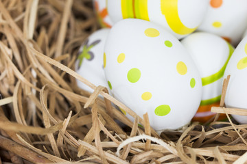 Colorful Easter eggs on a hay