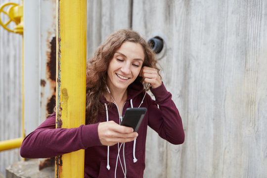 Happy woman listening to music on mobile phone 