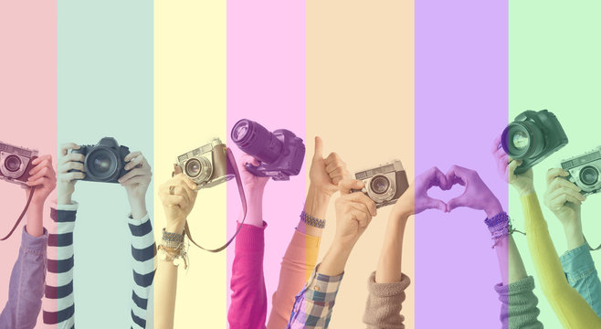 Different color hands and cameras also colorful background