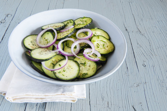 Cucumber salad with red onion and ground pepper.