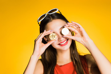 happy red dress woman holding a crypto currency